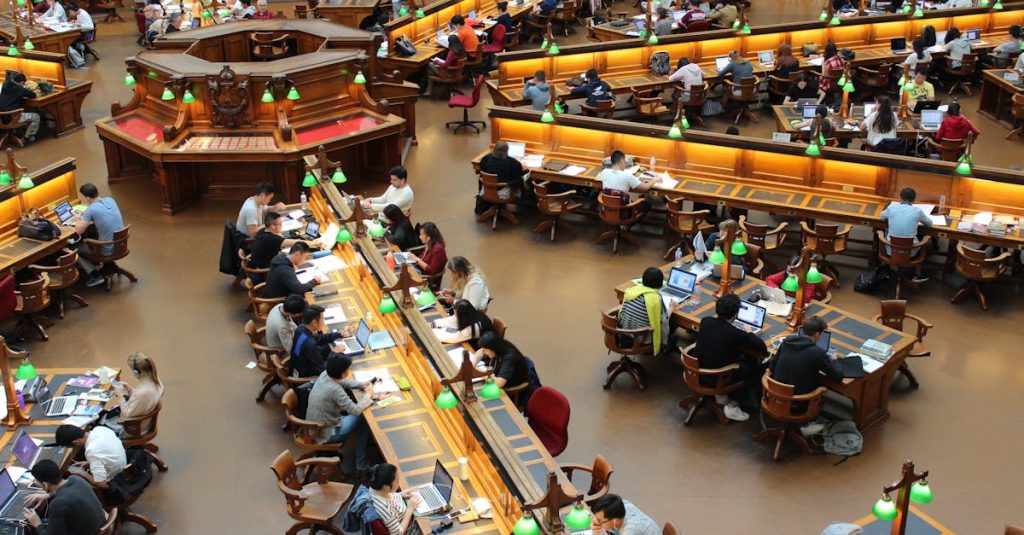 A lively university library scene with students studying diligently at wooden desks.