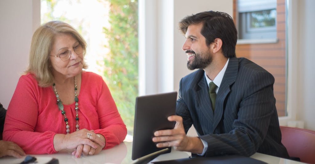 Elderly woman consulting with a realtor about a property deal in a cozy indoor setting.